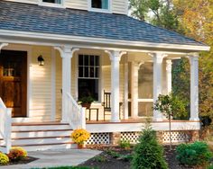 a white house with porch and steps leading to the front door