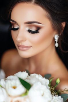 Bride with elegant makeup holding a bouquet of white flowers. Bridal Makeup With Brown Eyes, Wedding Makeup For Black Hair, Smokey Eye Wedding Makeup Brides, Bridesmaid Makeup Glam, Edgy Bridal Makeup, Wedding Makeup Looks For Brown Eyes, Romantic Glam Makeup, Makeup For Brides Wedding Day, Sultry Wedding Makeup