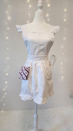 a white dress on a mannequin with lights in the background