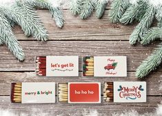 christmas matchboxes with merry and bright matches on them sitting next to pine branches