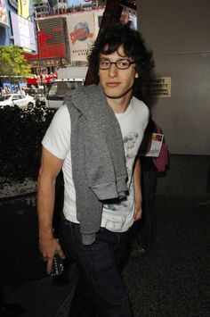 a man with glasses and a scarf on