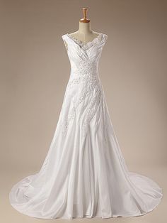 a white wedding dress on a mannequin