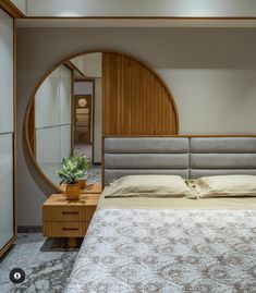 a bedroom with a bed, dresser and mirror in the corner that has a plant on it