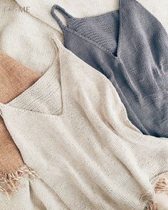 three sweaters laying on top of each other