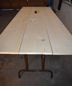 a wooden table sitting inside of a garage