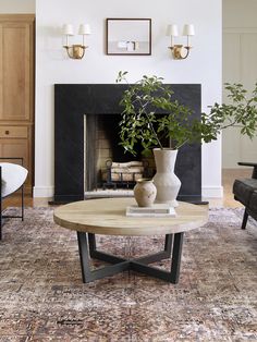 a living room filled with furniture and a fire place in front of a fireplace covered in plants