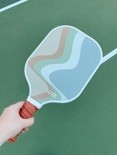 a person holding a tennis racquet on top of a tennis court with the words live written on it