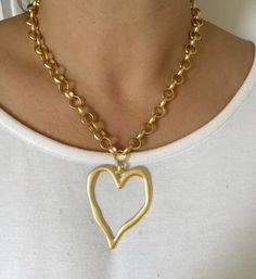 A really striking, oversized matte gold heart necklace featuring a statement hollow heart pendant on a chunky plated chain. This is a great piece for adding the wow factor to an everyday outfit. Despite being sizeable, it is very lightweight and comfortable to wear and looks awesome with an open neckline. ▪️22 Karat gold plated brass ▪️Heart - gold plated brass 62mm x 50mm ▪️Choose an oval link or belcher chain ▪️The necklace will be presented in attractive Scraffs gift packaging ready to gift or keep Gold Heart Pendant Chain Necklace, Gold Chunky Heart-shaped Jewelry, Chunky Heart-shaped Gold Jewelry, Chunky Heart-shaped Gold Necklace, Chunky Heart Shaped Gold Jewelry, Gold Open Heart Necklace For Party, Gold Chunky Heart Necklace, Chunky Gold Heart Necklace, Presents For Girlfriend