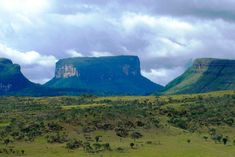 an open field with mountains in the background