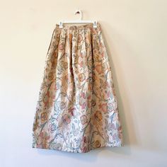 "Vintage skirt from the late 70s / early 80s. Brand is Cloak of Many Colors by Liberty & Lucrezia. If you've never heard of the brand it will become one of your favorites for their quality work! Full length maxi skirt that has a heavy tapestry jacquard fabric. Made from a polyester and spun rayon blend and is fully lined. High waisted fit with zip closure. In very good vintage condition. Super beautiful statement piece! Marked size 10.  Waist: 14\"  Length: 36\" N ABOUT SHOPPE: Mint Moon Shoppe Vintage Silk Long Skirt, Vintage Floral Print Long Maxi Skirt, Vintage Floral Print Maxi Skirt, 80s Skirt, Vintage Rock, Jacquard Fabric, Cloak, Vintage Skirt, Vintage 70s