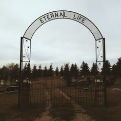 an entrance gate to a cemetery with the word eternal life on it's side