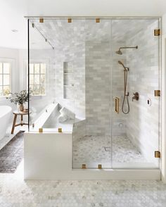 a bathroom with a walk in shower next to a bath tub