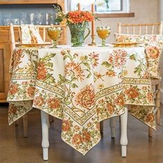 a dining room table with flowers on it