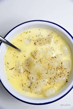 a white bowl filled with soup on top of a table