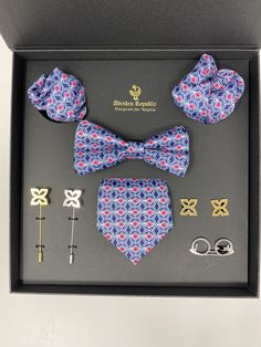 This beautiful luxury collection is well designed with craftsmanship to the modern man. In this set is the Face Mask, The Tie, The Bow tie, The Lapel Pin, The Cufflinks and The Tie Clip. Description 100% Handmade Silk Gold and Silver Finishing The Symbol is Fawohodie. FAWOHODIE:"independence" Symbol of independence, freedom, emancipation. From the expression: Fawodhodie ene obre na enam. Literal translation: "Independence comes with its responsibilities." Elegant Groom's Set With Ties, Elegant Sets With Ties For Groom, Classic Gold Formal Sets, Classic Gold Sets For Formal Occasions, Elegant Suit And Tie Accessories With Gift Box, Classic Gold Sets For Business, Luxury Silver Suit And Tie Accessories For Business, Elegant Multicolor Formal Sets, Elegant Suit And Tie Accessories Gift Box