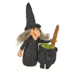 a needle - felted wizard doll holding a green pot with a wooden spoon