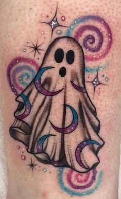 a tattoo with a ghost on it's thigh and stars around the leg area