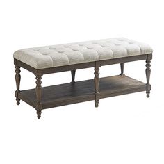 a wooden bench with a white upholstered cushion on it's top shelf