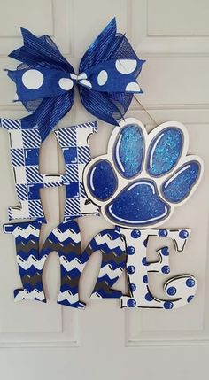 a blue and white door hanger with a dog's paw on it