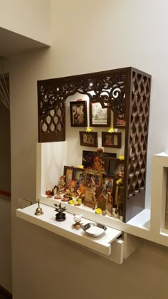 a display case with pictures and other items on the shelf in front of it,