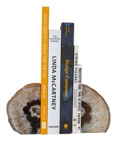 three books are stacked on top of each other in the shape of a half - eaten piece of fruit