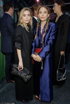 two women standing next to each other at an event