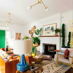 a living room filled with furniture and a fire place next to a green front door