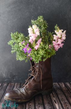 a boot with flowers in it sitting on a table