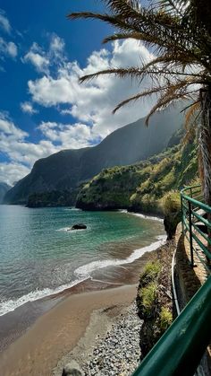 the beach is next to some mountains and water