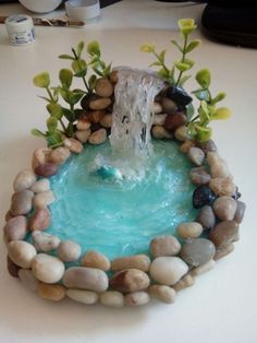 a small fountain made out of rocks and water