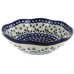 a blue and white bowl with flowers on it's rim, in the shape of a flower