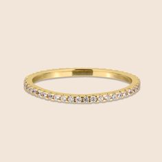 Simple and elegant, this alluring French Pave Eternity Ring will be a fabulous addition to your stack with its subtle, minimalistic design. This ring is ideal for stylish and fashionable modern women. This beautiful ring is the perfect choice for a wedding band or as a gift to a loved one on a special occasion. It is an ideal accessory for both casual events and formal occasions. Pair with a neutral dress of a darker tone. Features: Comfortable to wear Lightweight High quality Tarnish resistant Half Eternity Moissanite Band, Classic Vvs Clarity Eternity Band, Classic Stackable Moissanite Diamond Ring, Classic Cubic Zirconia Half Eternity Stackable Rings, Classic Cubic Zirconia Bands, Luxury Stackable Eternity Band For Promise, Cubic Zirconia Eternity Band With Halo, Elegant Moissanite Stackable Rings, Luxury Stackable Promise Eternity Band