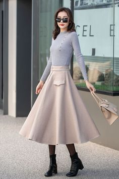 "This beige wool skirt is elegant and comfortable, which is the best choice for winter. DETAIL * More choices https://etsy.me/3Pwo3Fj * 30% wool, 30% fiber, 40% polyester * polyester lining * Two pockets * Back zipper closure * Below knee length effect * Perfect for autumn winter * Dry cleaning * Lean More about the items From the FAQs on the page bottom * The model is 170 cm (5′ 7″) tall with a 80 cm (31.5\") bust, 66 cm (26\") waist. She is wearing the plaid wool skirt in size XS. CUSTOM MADE Chic A-line Winter Skirt, Elegant A-line Bottoms For Winter, Formal Full Beige Skirt, Elegant Beige A-line Skirt, Beige A-line Pleated Skirt For Fall, Winter Formal Pleated Skirt, Elegant Solid Pleated Skirt For Winter, Elegant Flared Skirt Bottoms For Winter, Beige Long Skirt For Formal Occasions