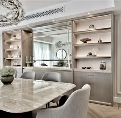 an elegant dining room with marble table and chairs