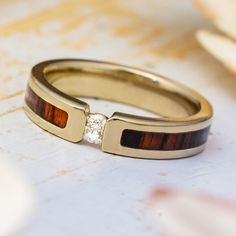 two wedding rings with wood and diamond accents