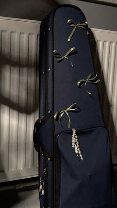 a blue guitar case sitting on the floor next to a radiator