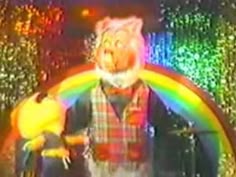 an image of a man with a rainbow in his hand and a cat on the other side