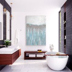 a bath room with a large painting on the wall and a tub in front of it