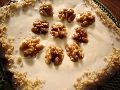 a pie with walnuts on top sitting on a table