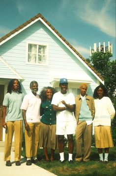 a group of people standing in front of a house