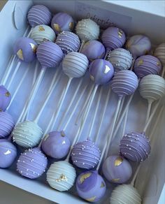 purple and white cake pops in a box