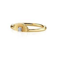 a yellow gold ring with a diamond in the center