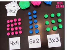 the table is covered with different colored plastic balls and numbers for each individual to place on