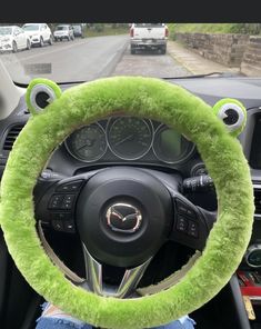 the steering wheel cover is green and fuzzy