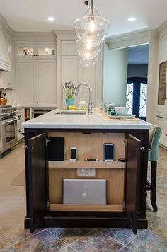 a kitchen island with an open laptop on it