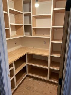 an empty closet with wooden shelves and no doors on the door is seen in this image