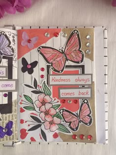 an altered book with butterflies and flowers on it