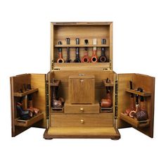 an open wooden cabinet with many different items in it