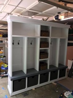 a room filled with lots of white shelves and bins