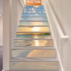 stairs leading up to the beach with sunset in the sky and clouds painted on them